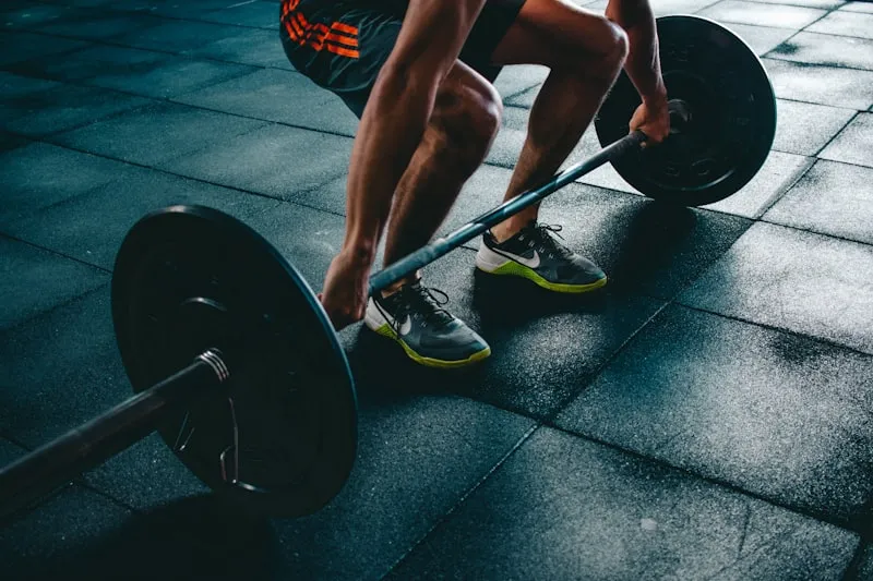 Person lifting weights in a well-equipped gym